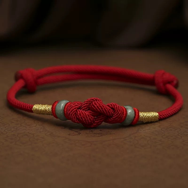 Red string jade bracelet symbolizing protection, luck and daily intention
