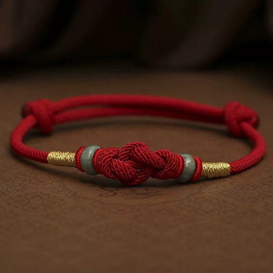 Red string jade bracelet symbolizing protection, luck and daily intention