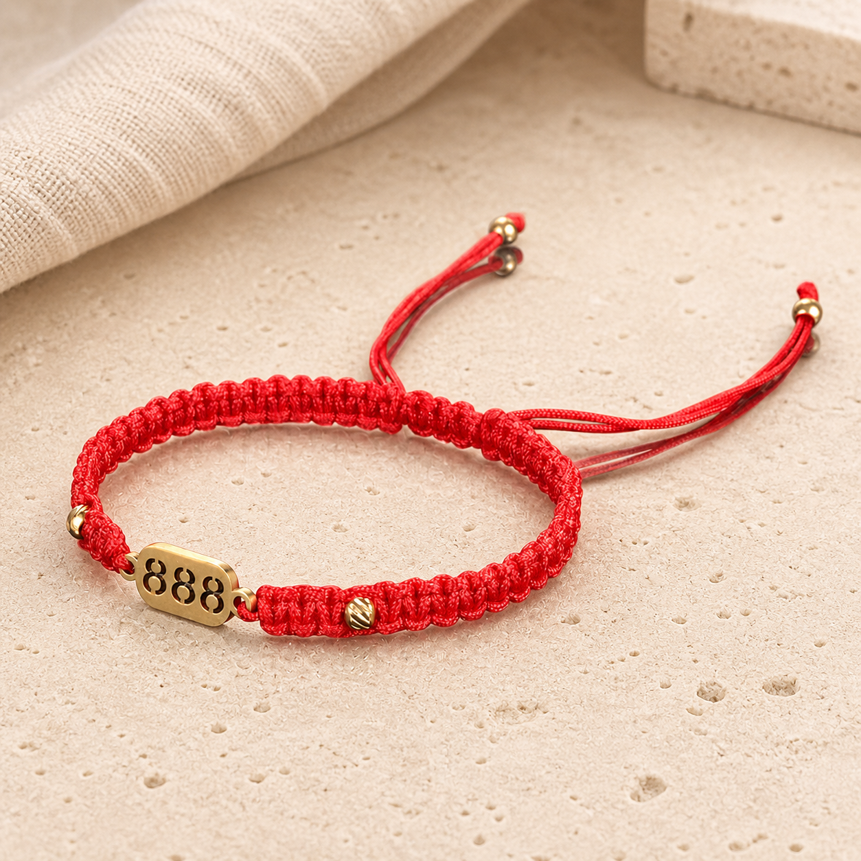 888 Angel Number Bracelet angled detail showing the red braid, gold beads and 888 plate