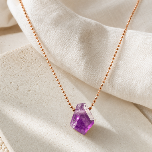 Amethyst necklace with copper ball chain on ivory linen
