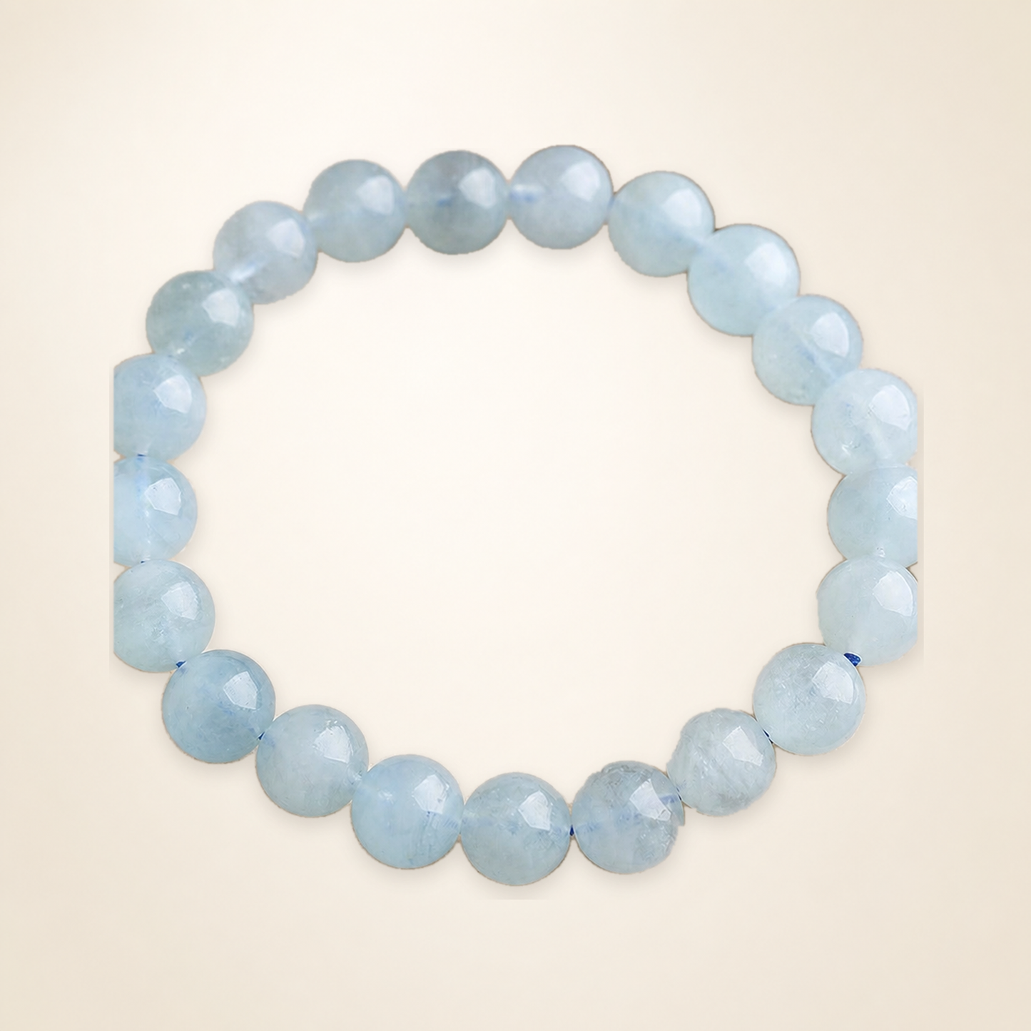Aquamarine bracelet on seamless warm ivory studio background