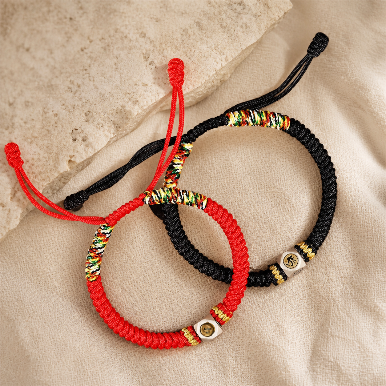 Red and black Chinese zodiac guardian rope bracelets shown together