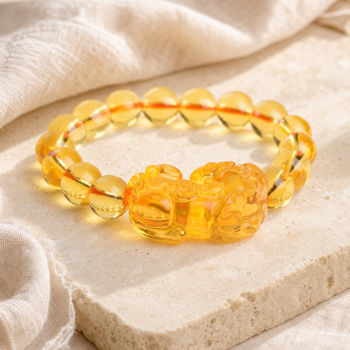 Citrine Pixiu bracelet on a light ivory background