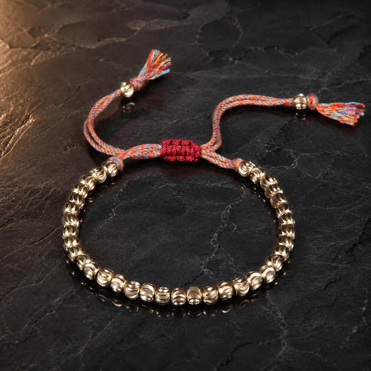 Copper Bead Bracelet dramatic reflective view with carved beads and red woven clasp