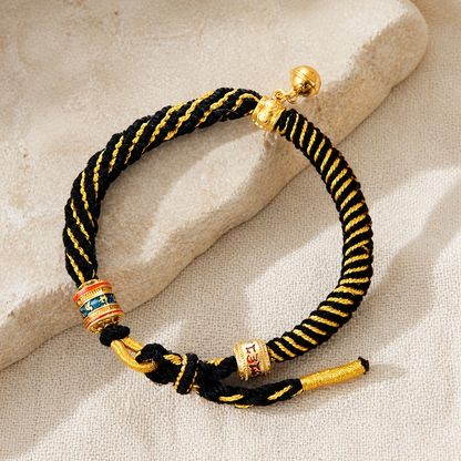 Black and gold woven bracelet on ivory linen