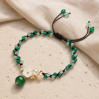 Green jade anklet full view on ivory stone