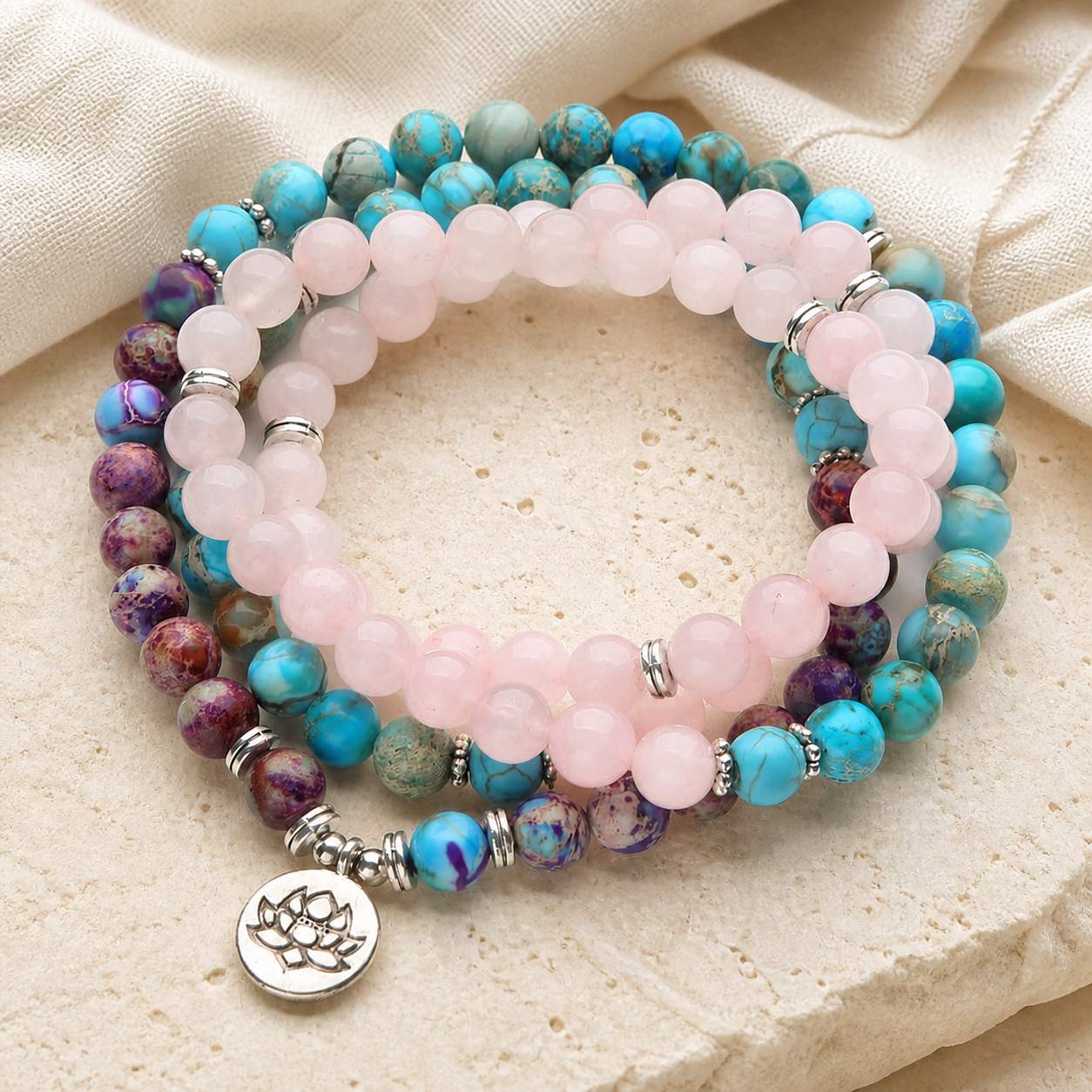 Lotus of Calm mala beads on warm ivory limestone