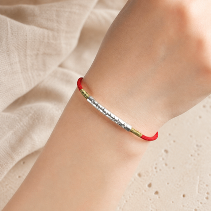 Red string bracelet close-up worn on a wrist